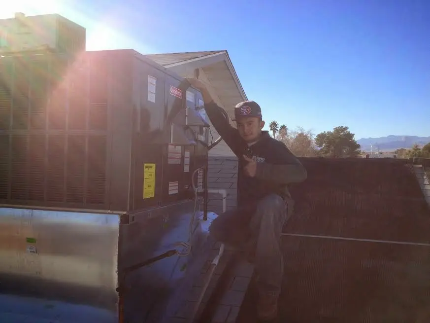 HVAC technician performing HVAC Inspection on a rooftop unit in Candlewick Lake